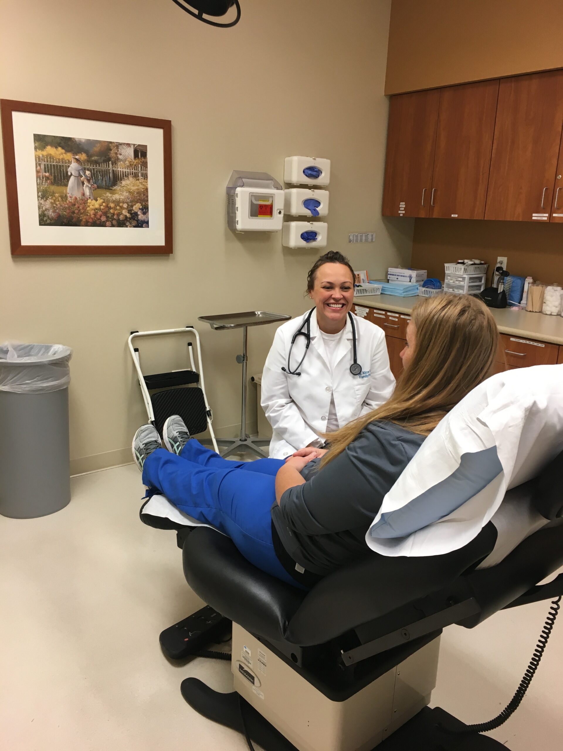 Photo of Alice Mann, MD, MPH, with a patient